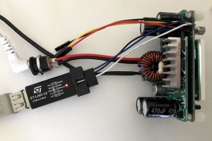 Debugger connected, UART cable at the top